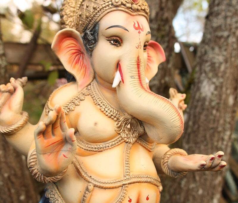 a Ganesh murti set on branches of a tree