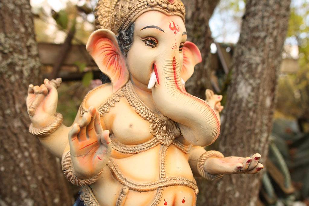 a Ganesh murti set on branches of a tree