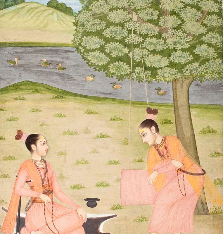 An 18th-century painting of two female ascetics in saffron robes by a river. One sits cross-legged on a black deerskin under a tree, while the other stands beside a rope swing. Ducks float on the river against gentle hills in the background.