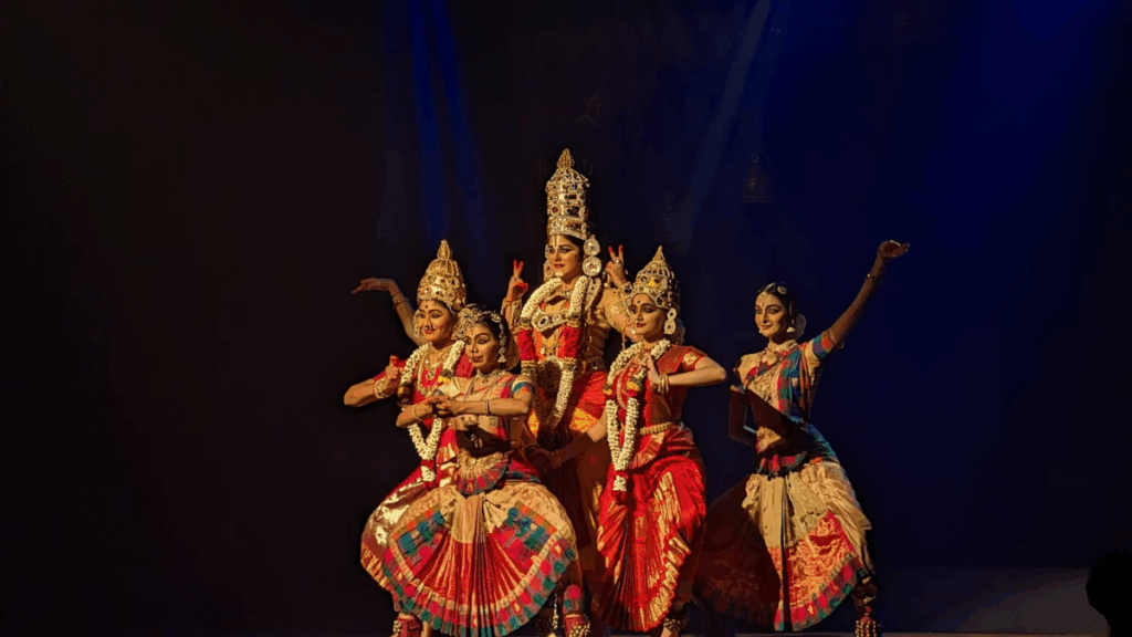 Five South Indian dancers in colorful costumes, depicting Maha Vishnu and his divine consorts.