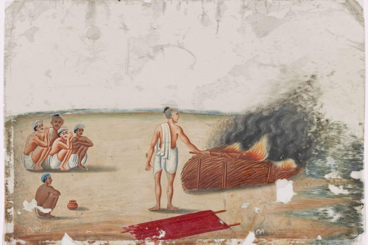 Historical Indian painting depicting a Hindu cremation ceremony, showing a chief mourner igniting a funeral pyre near the water while loved ones sit nearby in prayer.