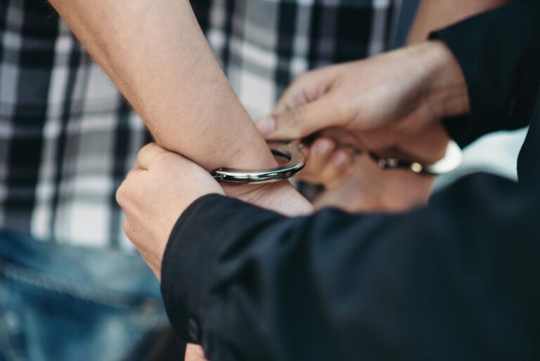 Close-up of a person being handcuffed